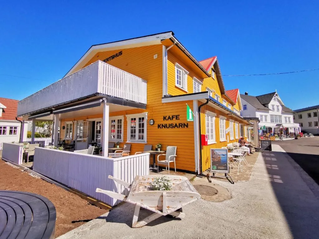 Henningsvær Guesthouse, a yellow building with a red roof in the heart of the artists' village of Henningsvær in the Lofoten Islands, Norway