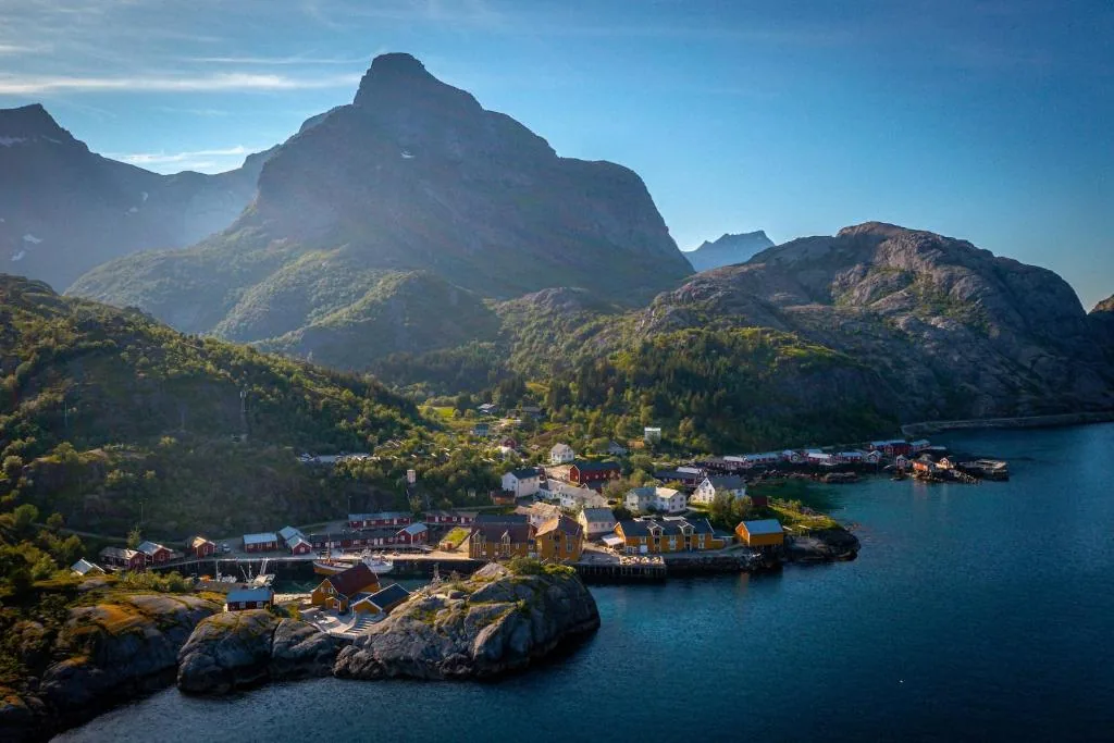 Nusfjord Village & Resort, red stilted rorbuer at the heart of a steep-walled fjord in the Lofoten Islands, Norway