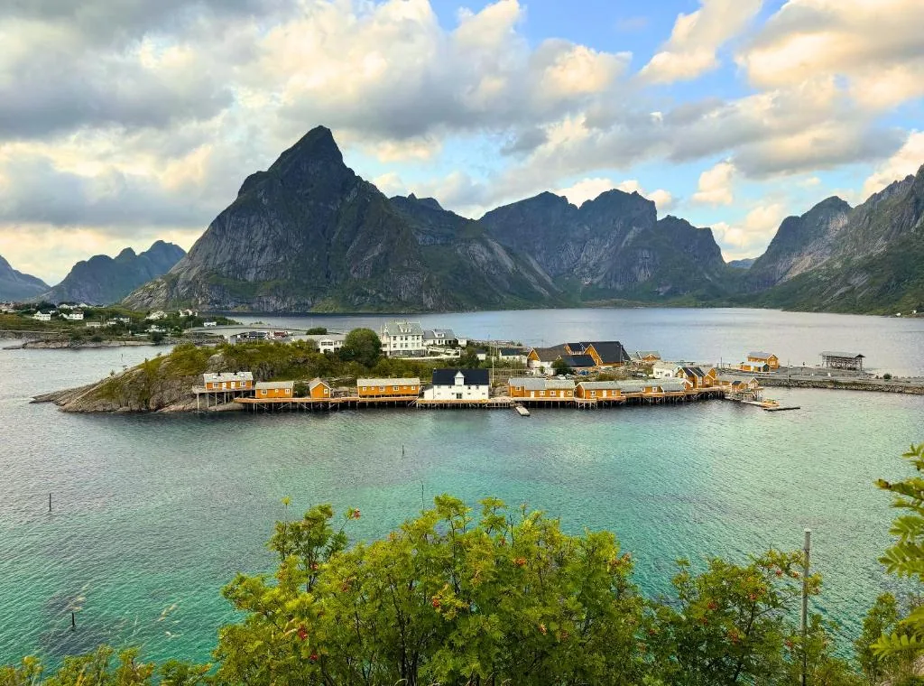 Sakrisøy Rorbuer, a small island of ochre-yellow cabins in the middle of the Reine fjord in the Lofoten Islands, Norway