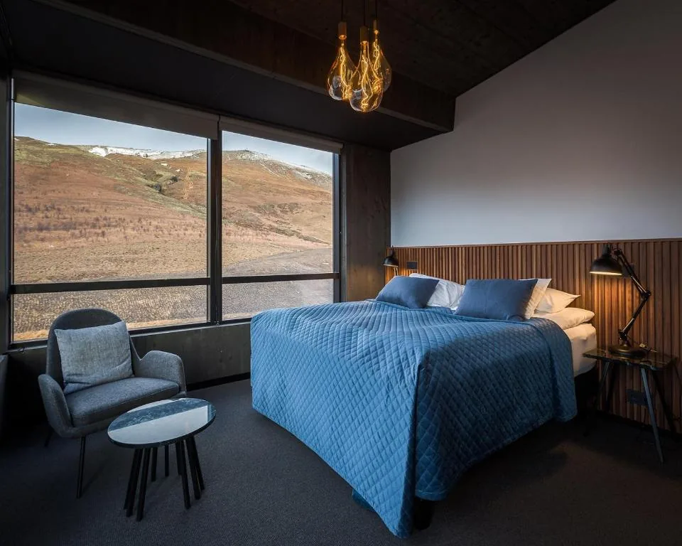 Executive Suite at the Fosshotel Glacier Lagoon with a large picture window and mountain view in south Iceland