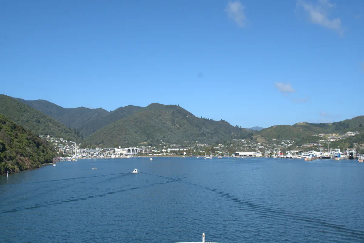 The port and town of Picton framed by hills, seen from the deck of the ferry arriving from Wellington.