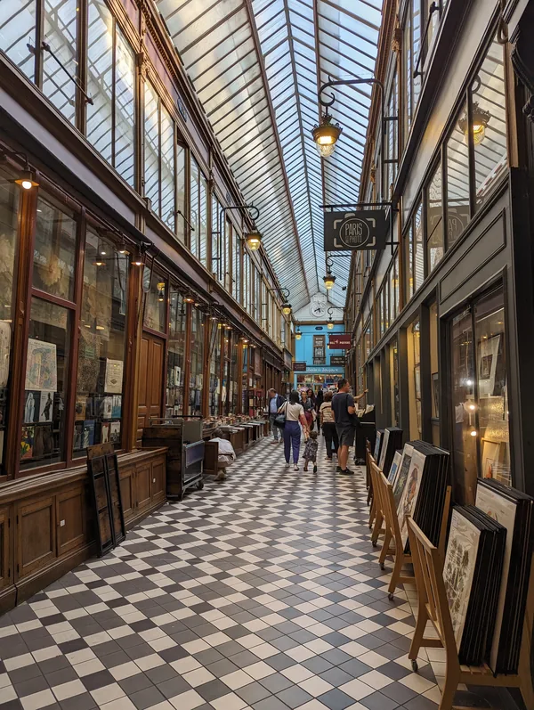 Covered passage of the Grands Boulevards in Paris Glass roof, chequerboard floor and gallery stalls in a covered passage of the Grands Boulevards district in Paris.