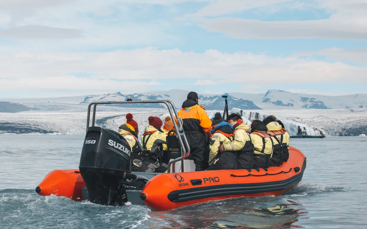 Zodiac boat trip on the Jökulsárlón glacier lagoon among the blue icebergs, Iceland